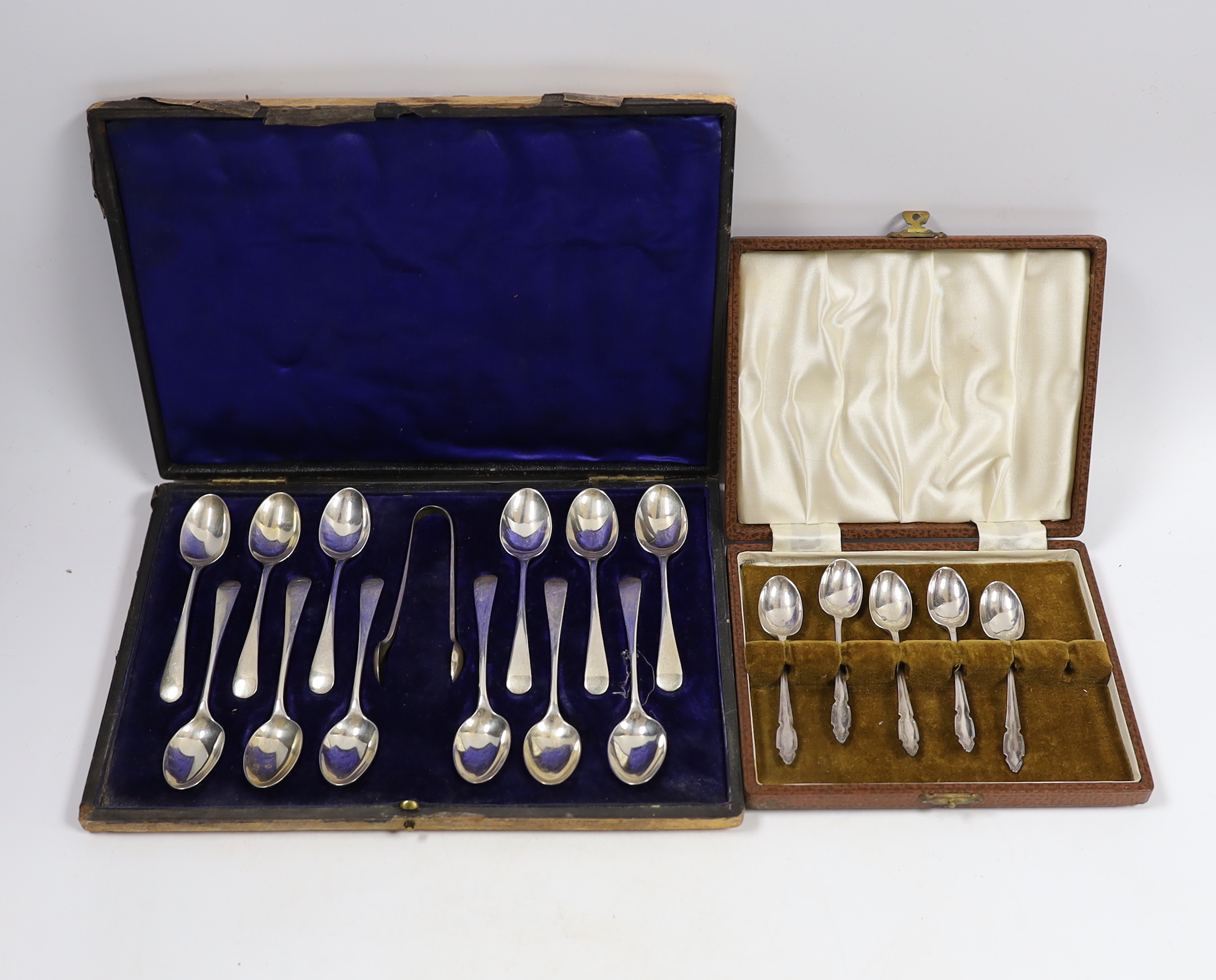 A cased set of twelve Edwardian silver teaspoons with tongs, William Hutton & Sons, London, 1905 and a cased set of five coffee spoons.